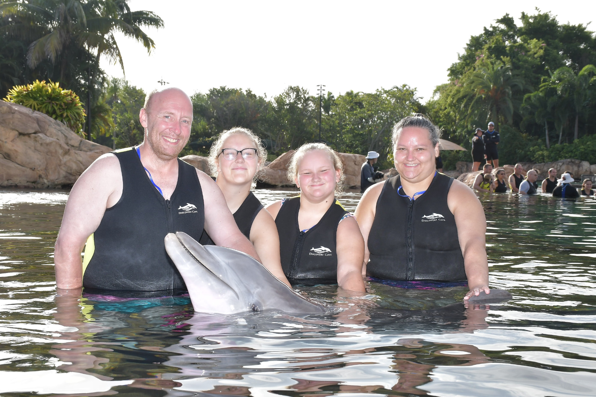 Elizabeth and her family with a dolphin at Discovery Cove